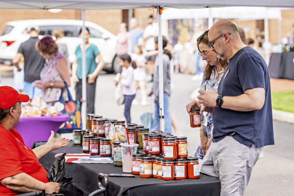 Couple shopping at a Farmers Market booth
